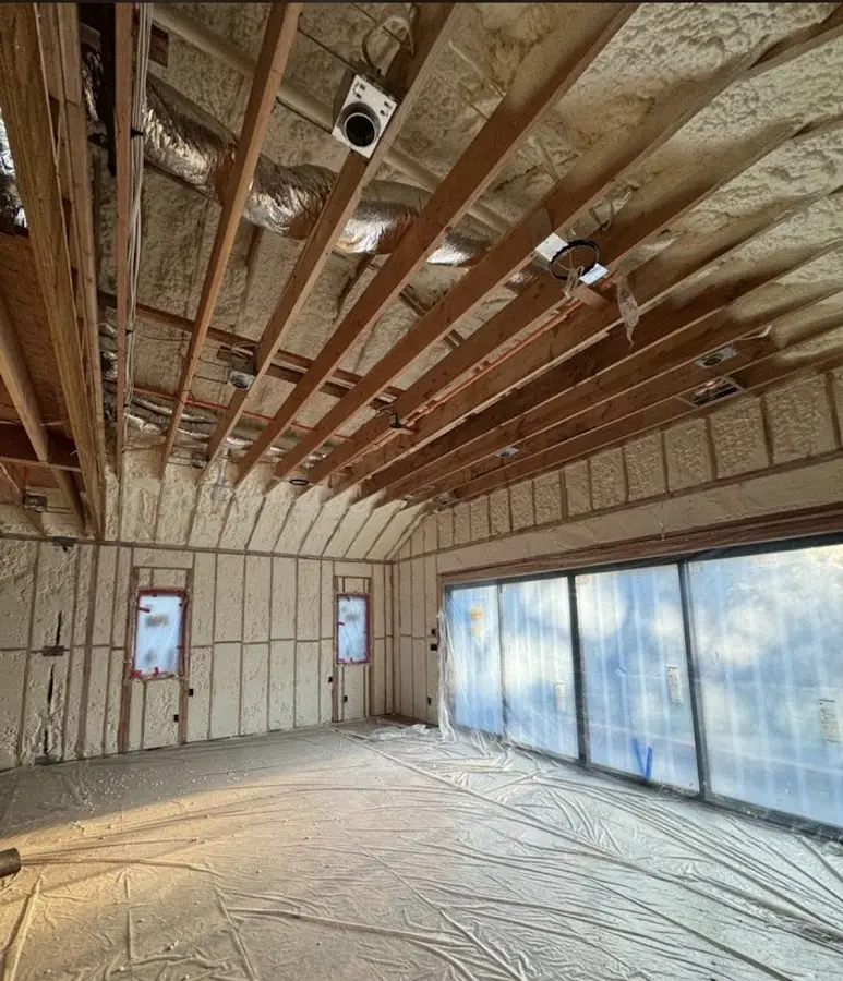 Interior walls and ceiling insulated with spray foam during new construction in Mexico
